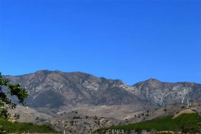 a living room with furniture a lamp and a large window