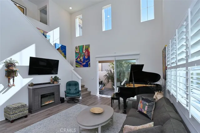 a sitting area with furniture and a wooden floor