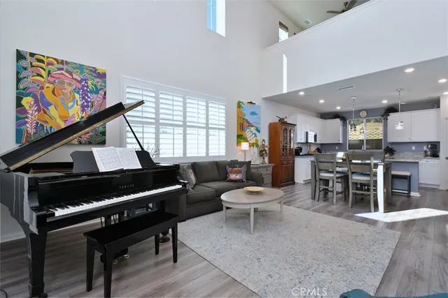 a living room with furniture a rug and a painting on the wall