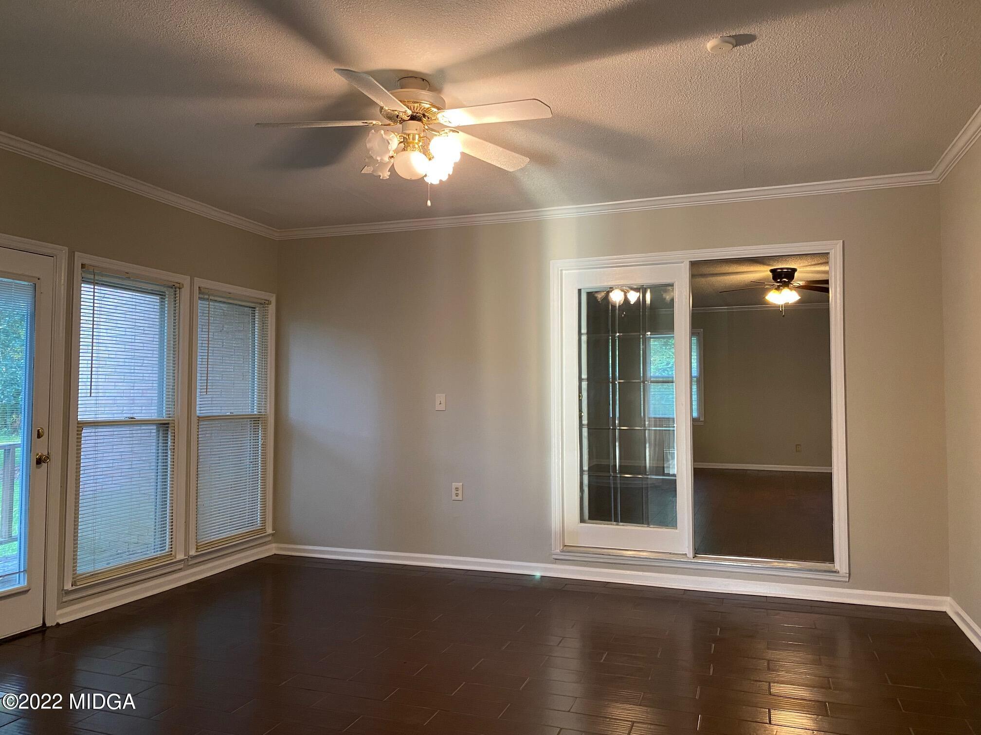 137 Glen Oaks Road Perry, GA 31069 - Photo 54 of 84 a view of an empty room with wooden floor and a window
