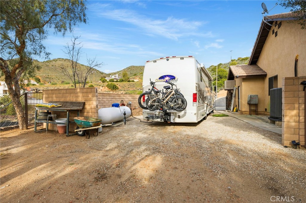 8634 Escondido Canyon Road Agua Dulce, CA 91390 - Photo 57 of 73 a view of a garage with a bike and white house