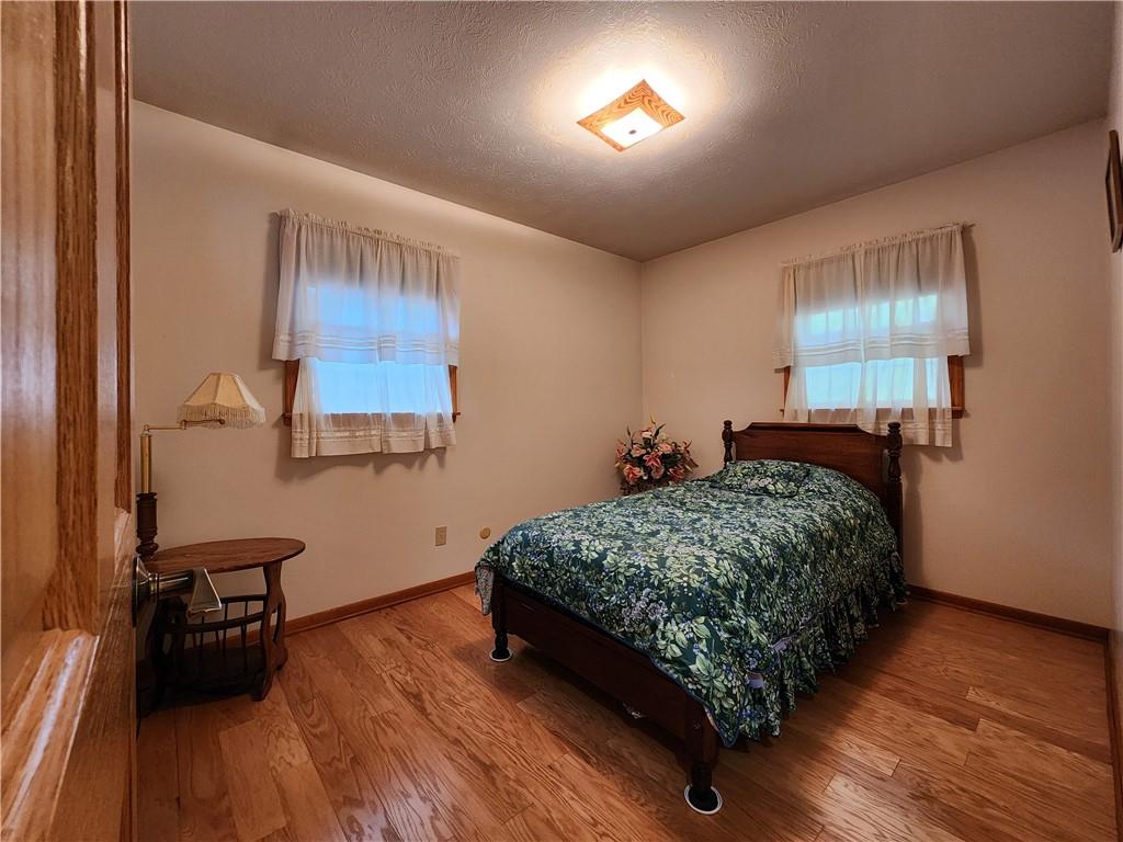 910 Latonka Drive Mercer, PA 16137 - Photo 24 of 38 a bedroom with a bed and a wooden floor