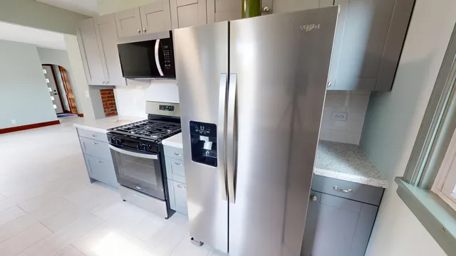 a view of an empty room with window and closet area