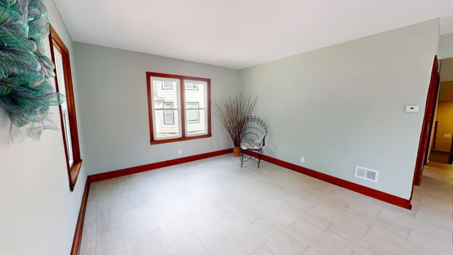 an empty room with closet and a chandelier fan