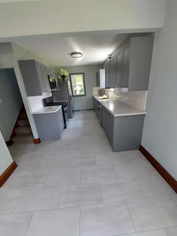 an empty room with a ceiling fan and window