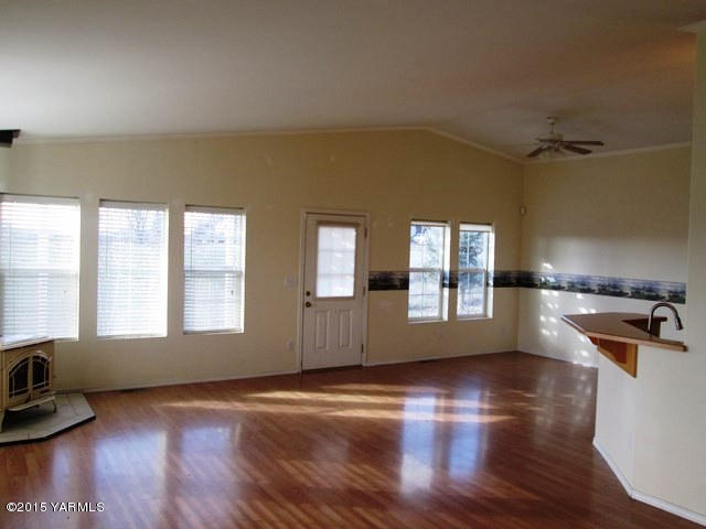 173401 West Johnson Road Grandview, WA 98930 - Photo 14 of 38 an empty room with wooden floor and windows