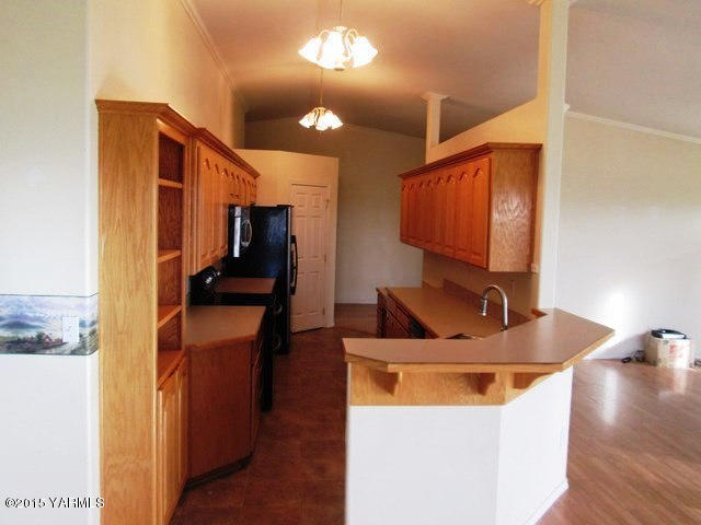 173401 West Johnson Road Grandview, WA 98930 - Photo 15 of 38 a kitchen with stainless steel appliances kitchen island granite countertop a sink and a refrigerator