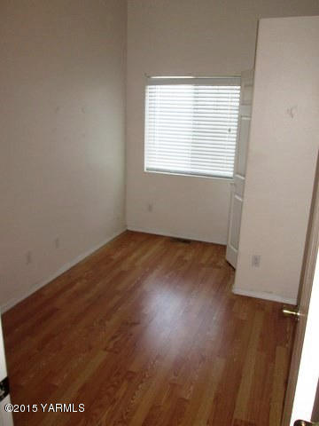 173401 West Johnson Road Grandview, WA 98930 - Photo 20 of 38 an empty room with wooden floor and windows