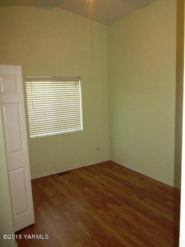 173401 West Johnson Road Grandview, WA 98930 - Photo 24 of 38 a view of an empty room with wooden floor and a window