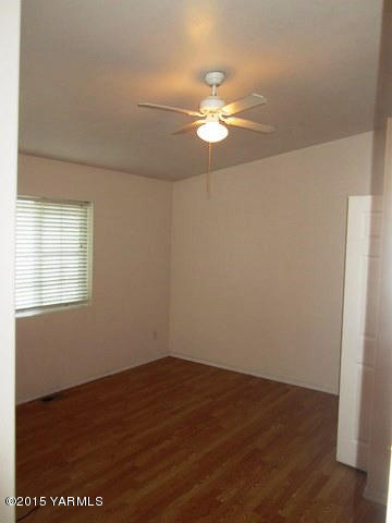 173401 West Johnson Road Grandview, WA 98930 - Photo 25 of 38 an empty room with wooden floor fan and window