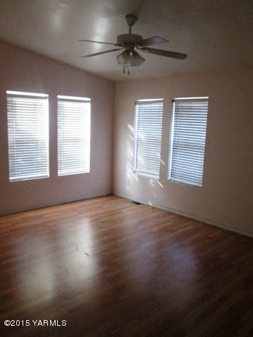 173401 West Johnson Road Grandview, WA 98930 - Photo 28 of 38 a view of an empty room with a window and wooden floor