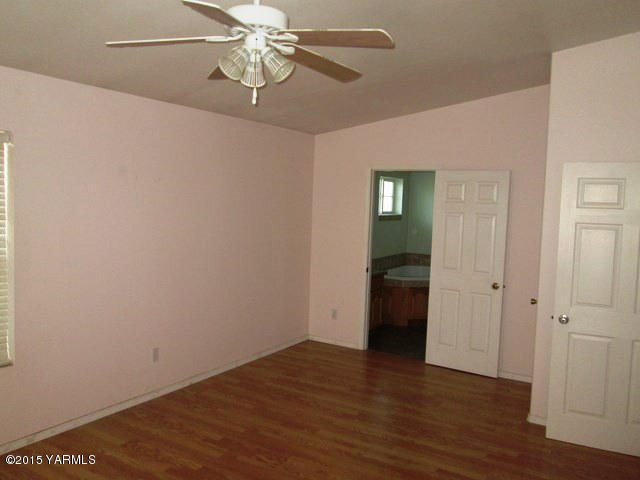 173401 West Johnson Road Grandview, WA 98930 - Photo 29 of 38 a view of an empty room with wooden floor
