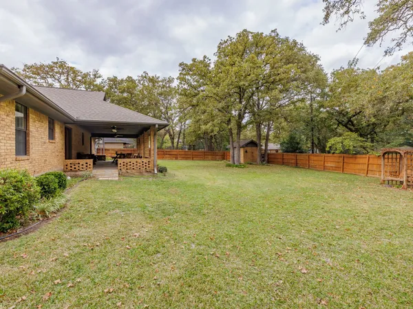 a view of a house with backyard and porch