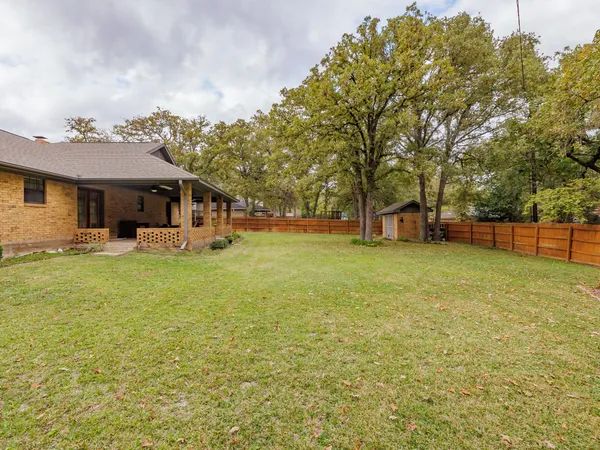 a view of a house with a yard and sitting area
