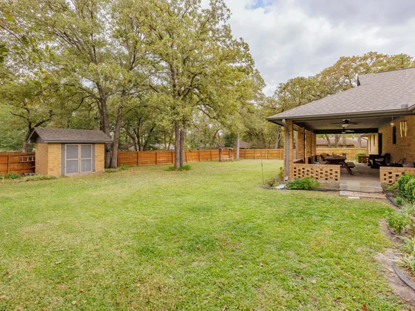 a backyard of a house with table and chairs