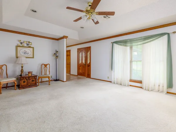 a view of a livingroom with a furniture and a ceiling fan