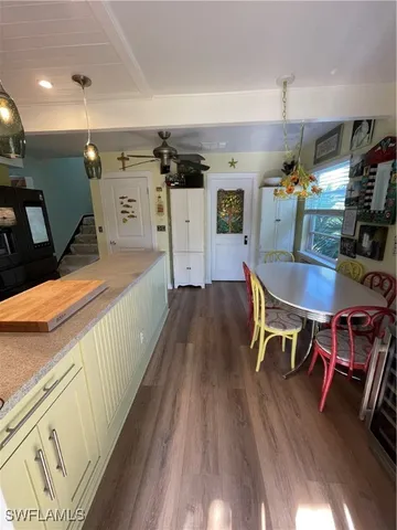 a living room with furniture and large windows