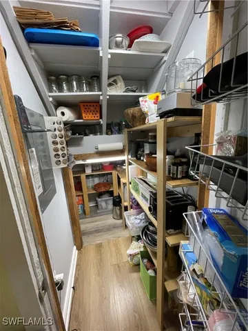 a kitchen with a refrigerator a stove and white cabinets