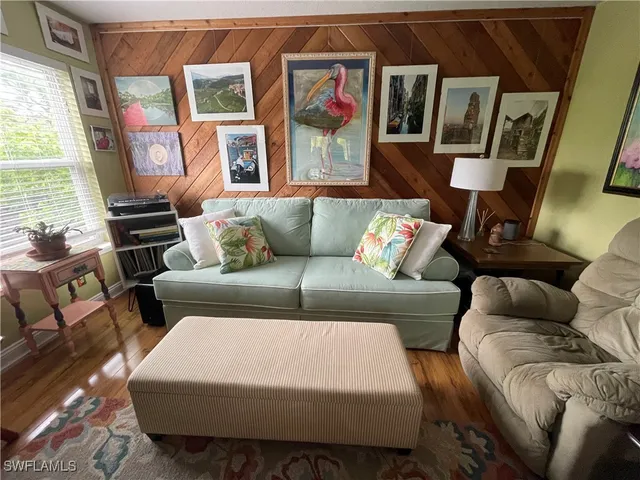 a very nice looking room with wooden floor and furniture