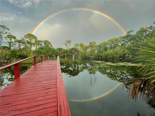 a backyard of a house with a yard and outdoor seating