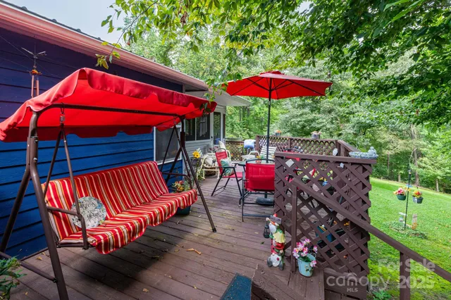 an outdoor sitting area with an umbrella a fire pit