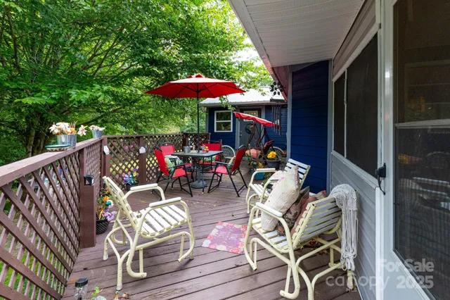 an outdoor sitting area with furniture and umbrella
