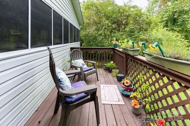 a view of a balcony with chairs and wooden floor