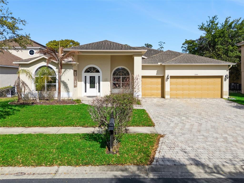 2541 Teton Stone Run Orlando, FL 32828 - Photo 17 of 82 a front view of a house with a garden