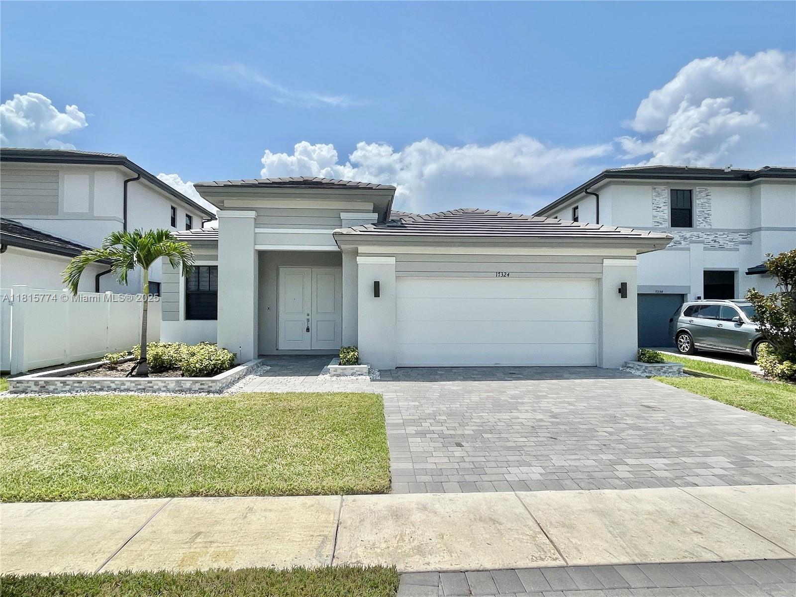 a front view of a house with garden