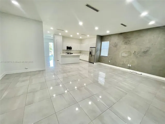 a large white kitchen with a large window
