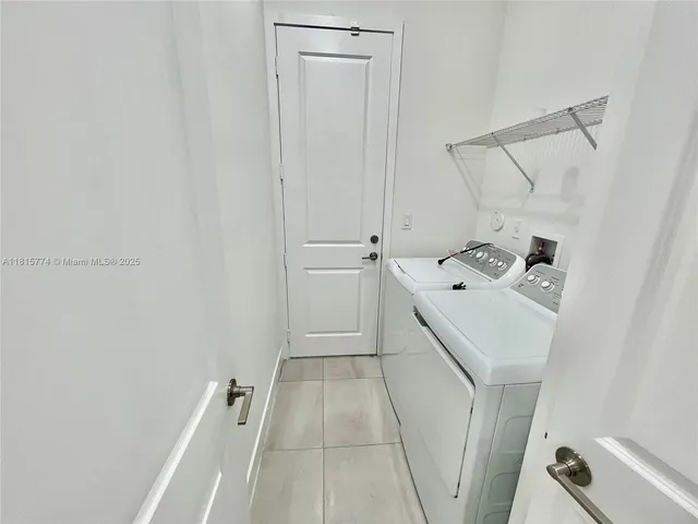 a view of a room with white tiles