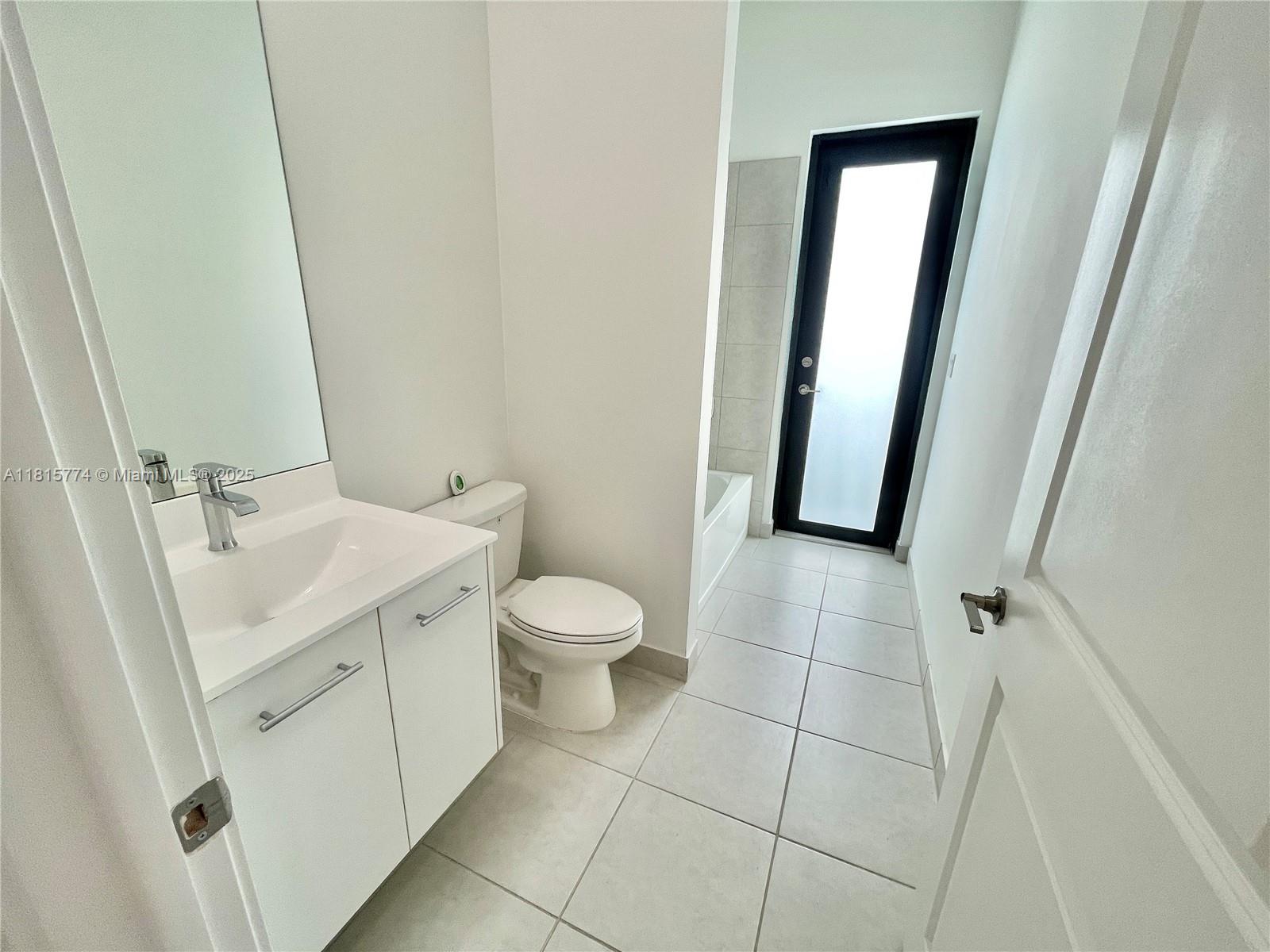 17324 Southwest 41st Street, Unit 17324 Miramar, FL 33029 - Photo 19 of 30 a bathroom with a sink and a mirror