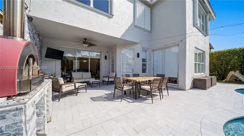 a view of a patio with dining table and chairs