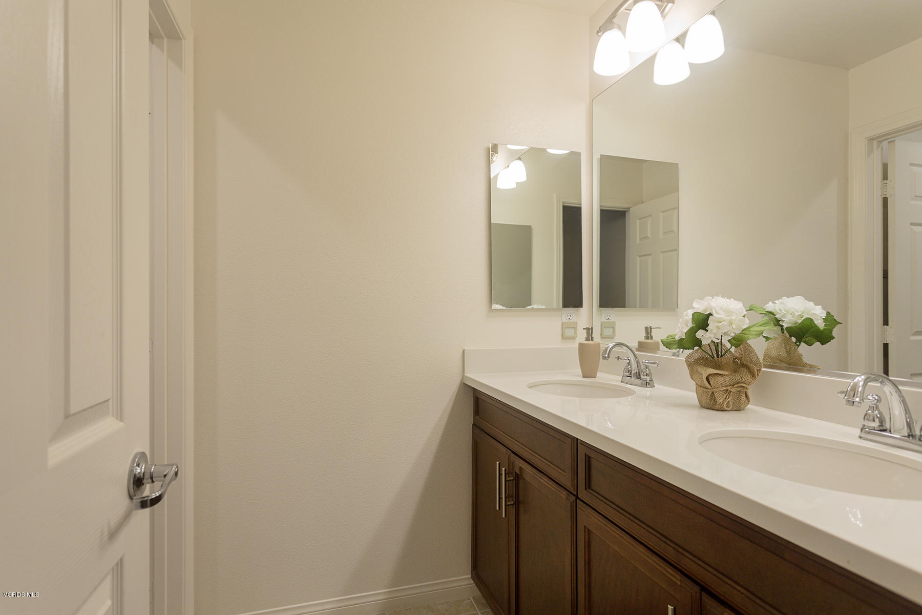 4909 Edenbridge Road Moorpark, CA 93021 - Photo 22 of 34 a bathroom with a double vanity sink and a mirror