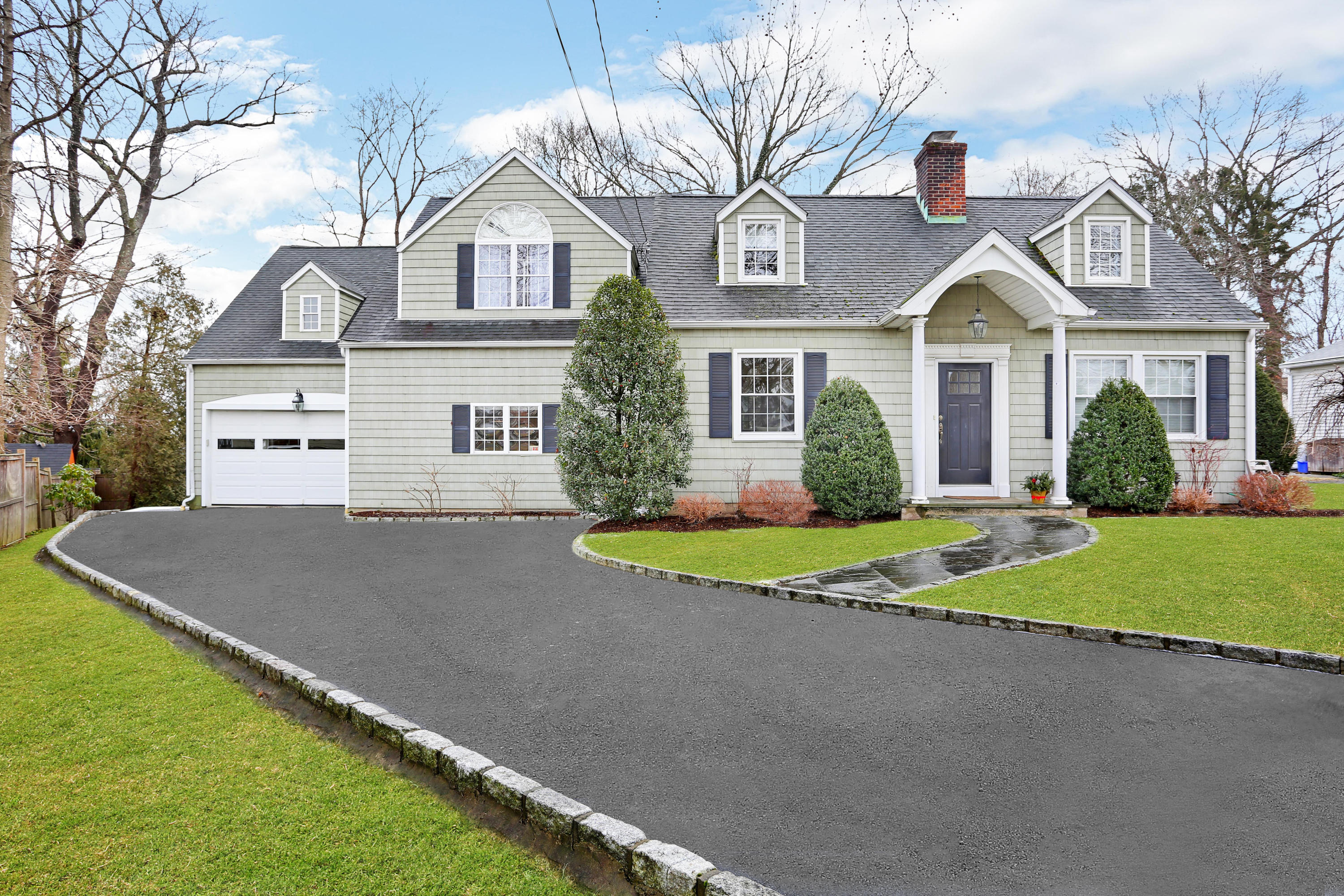 19 Walmsley Road Darien, CT 06820 - Photo 1 of 30 a front view of a house with a yard and garage
