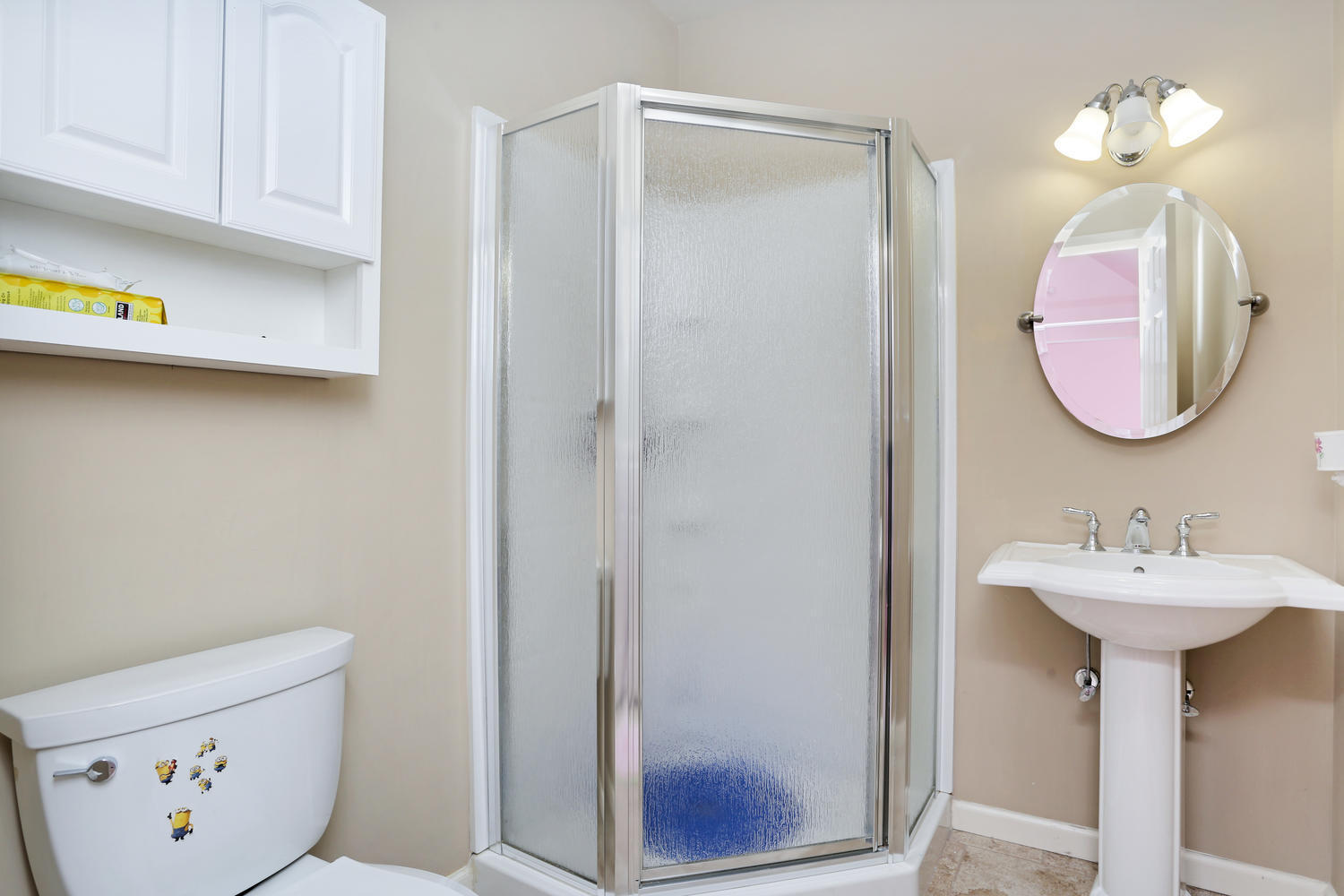 19 Walmsley Road Darien, CT 06820 - Photo 22 of 30 a bathroom with a sink a mirror and a light fixture