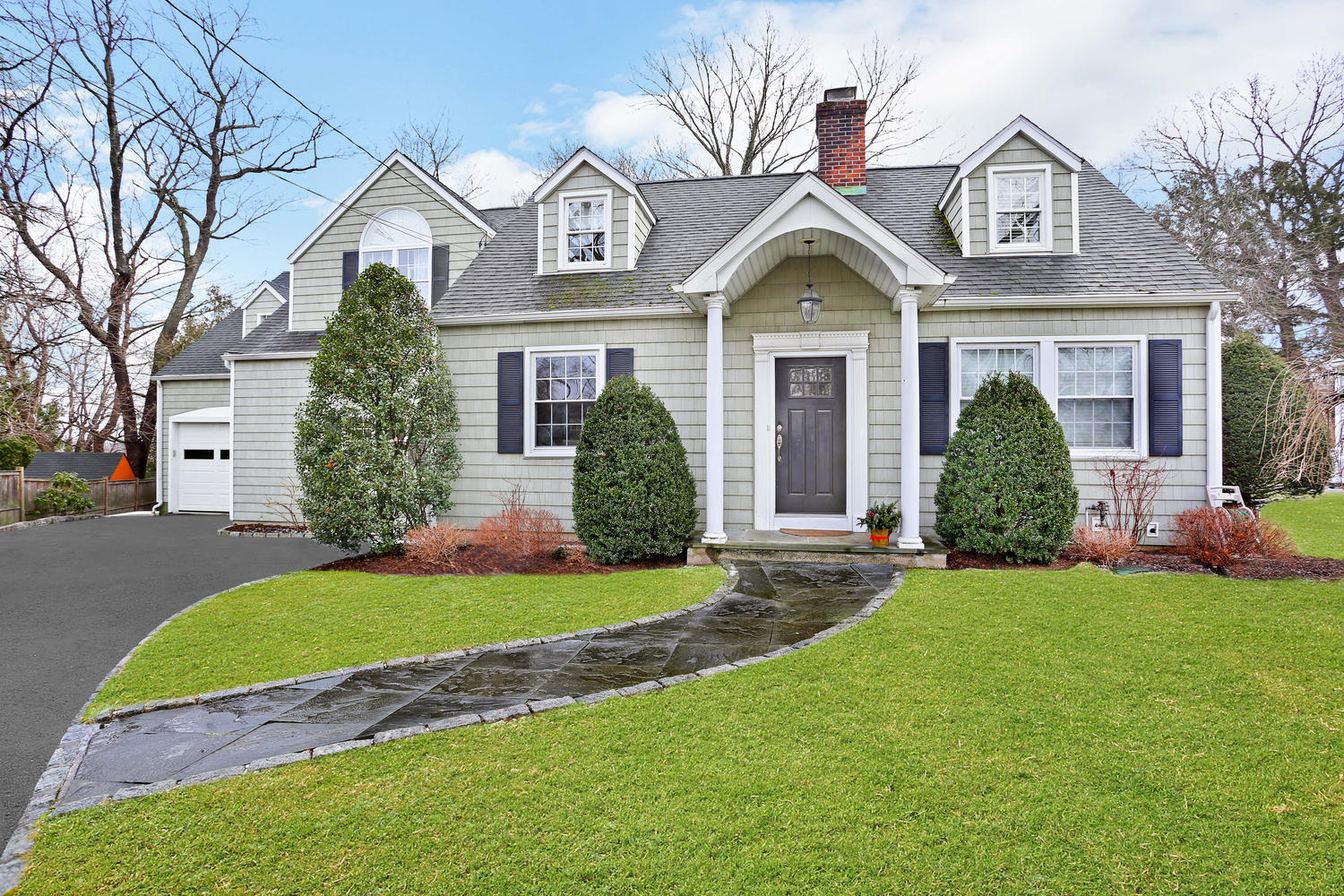 19 Walmsley Road Darien, CT 06820 - Photo 28 of 30 a front view of a house with a yard and garage