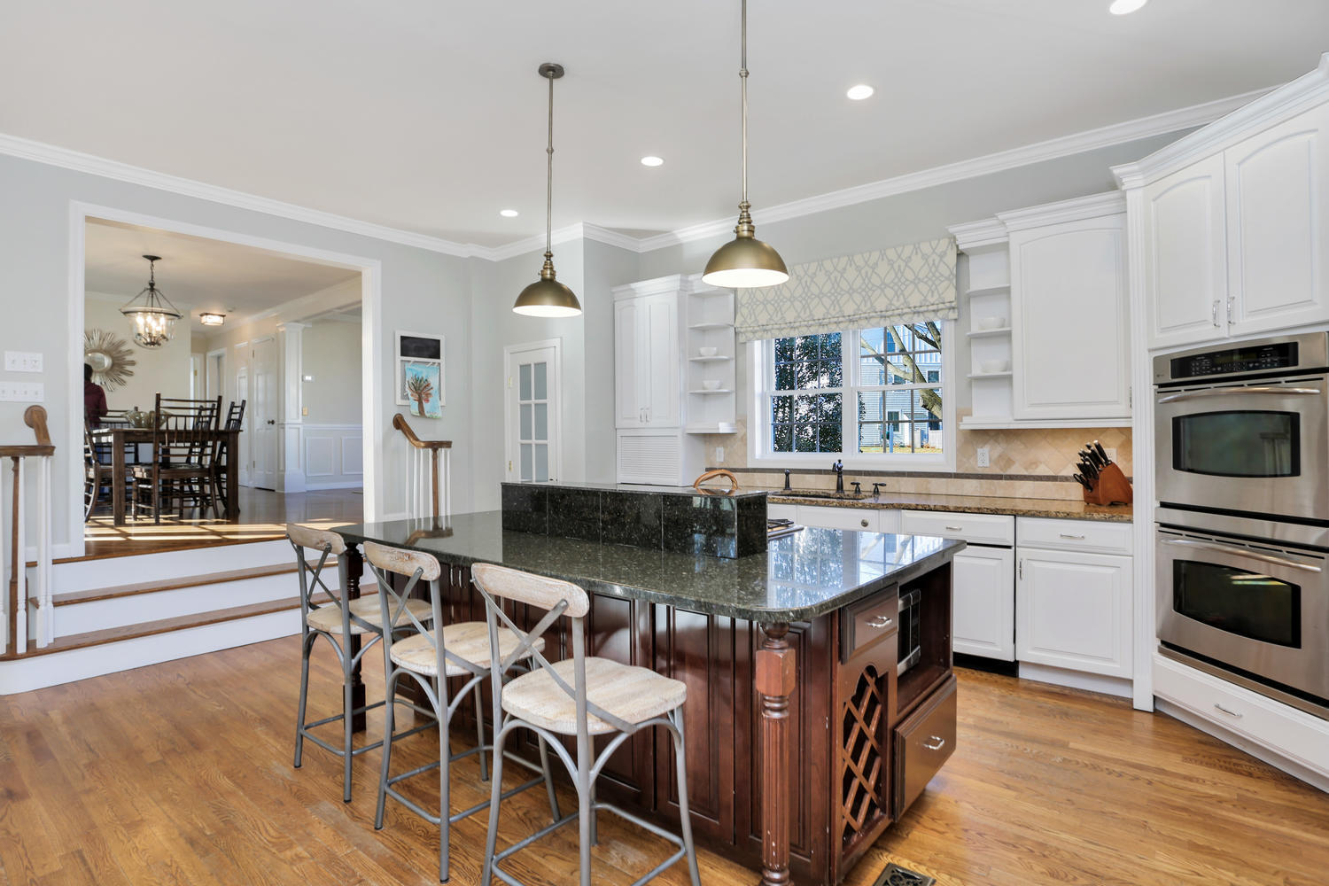 19 Walmsley Road Darien, CT 06820 - Photo 6 of 30 a kitchen with kitchen island granite countertop a table chairs sink and cabinets