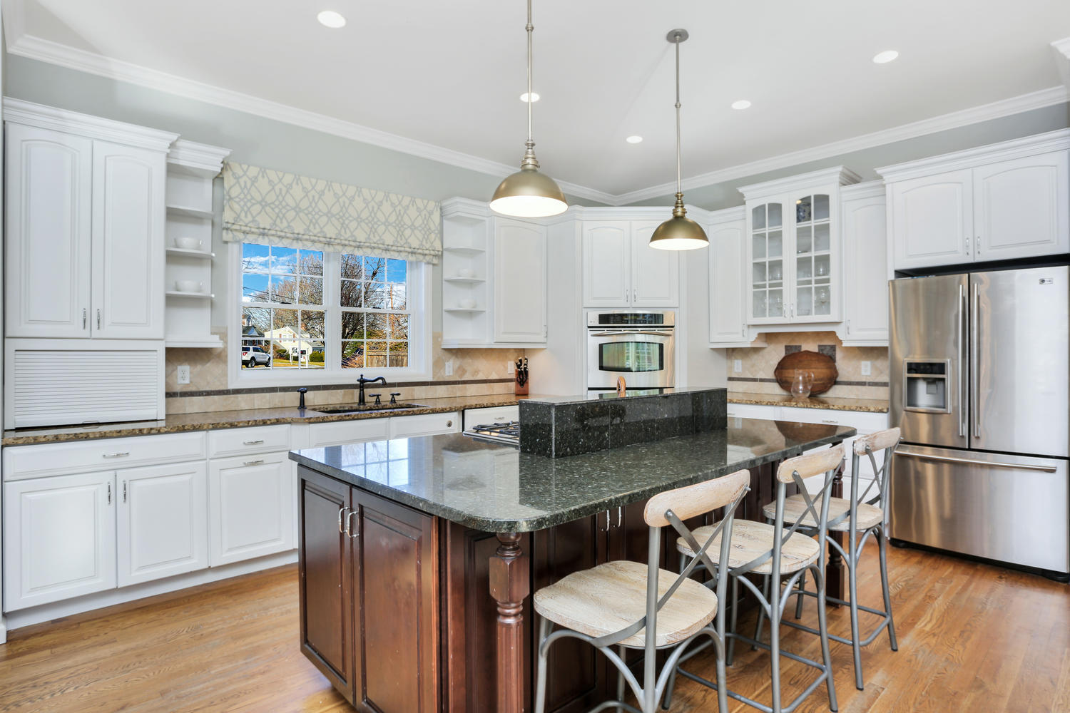19 Walmsley Road Darien, CT 06820 - Photo 8 of 30 a kitchen with granite countertop a table chairs stove a refrigerator and cabinets