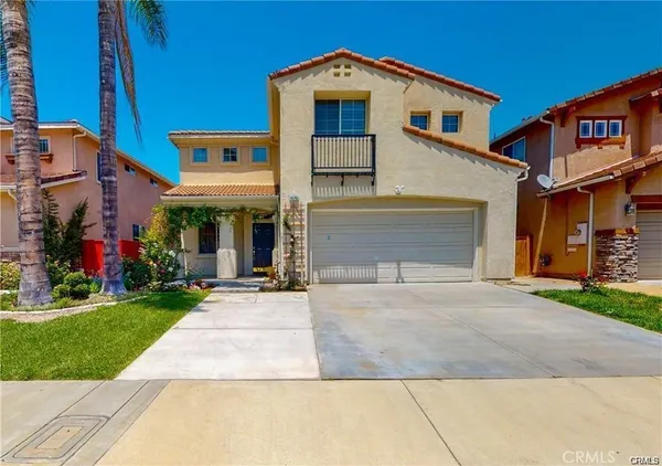 a front view of a house with a yard and a garage