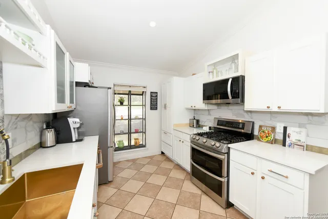 a kitchen with a stove a sink and a refrigerator