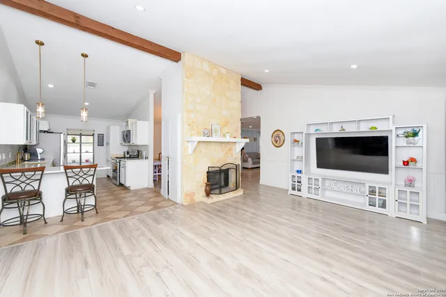 a view of a livingroom with furniture and a flat screen tv