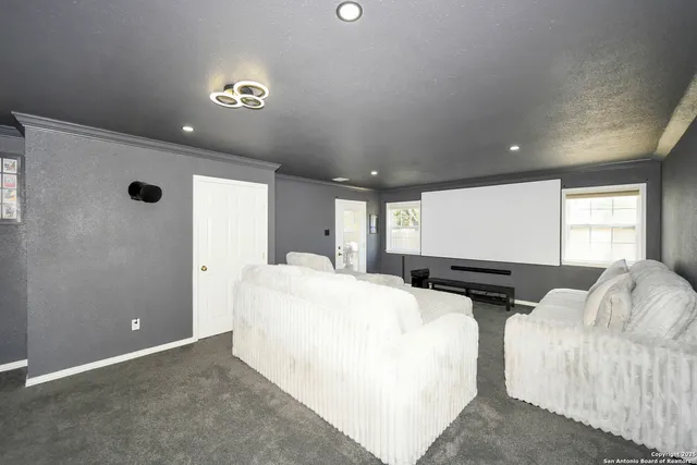 a view of living room with furniture and a projector screen