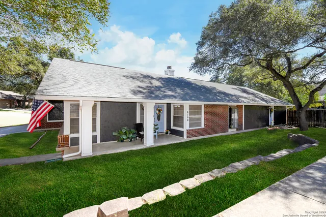 a front view of a house with a yard table and chairs