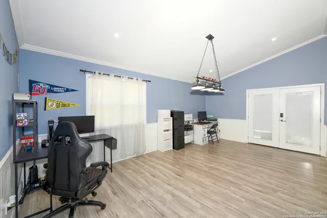 a view of a workspace with furniture and a window