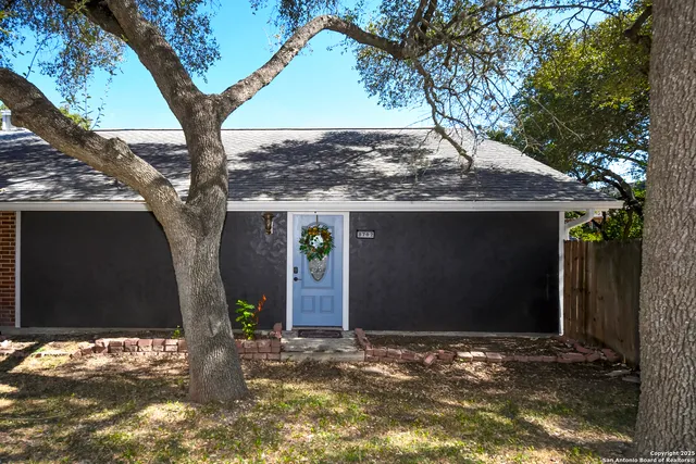 a view of a house with a tree