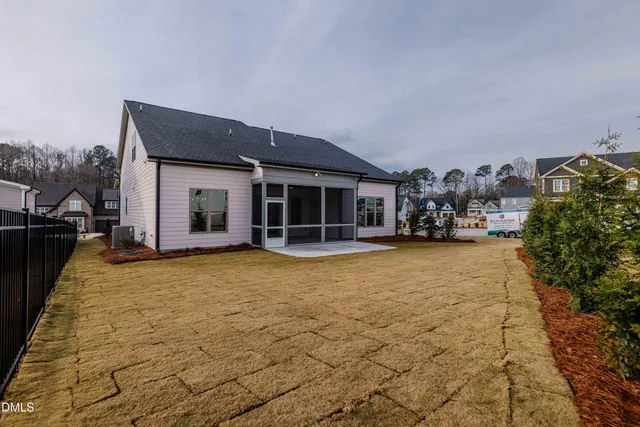 an empty room with wooden floor chandelier fan and windows