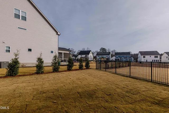 a view of an empty room with wooden floor and closet
