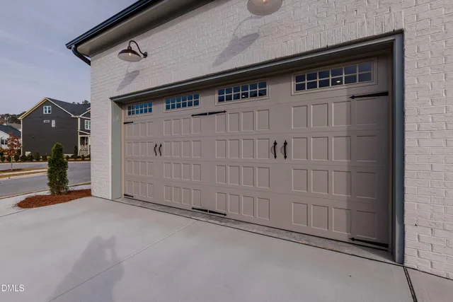an empty room with windows and entrance to other room