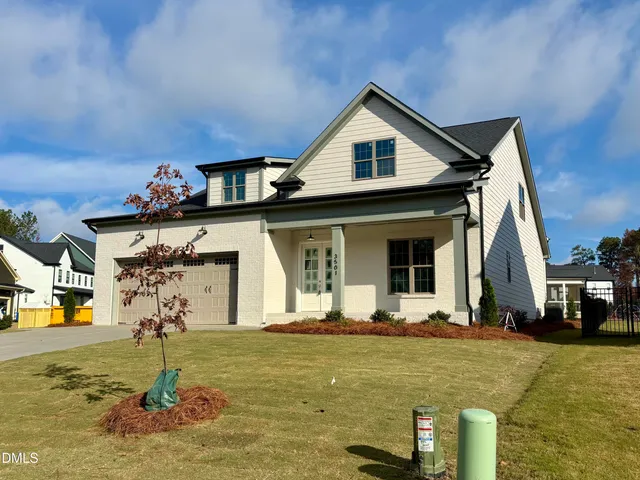 a view of a house with backyard porch and sitting area